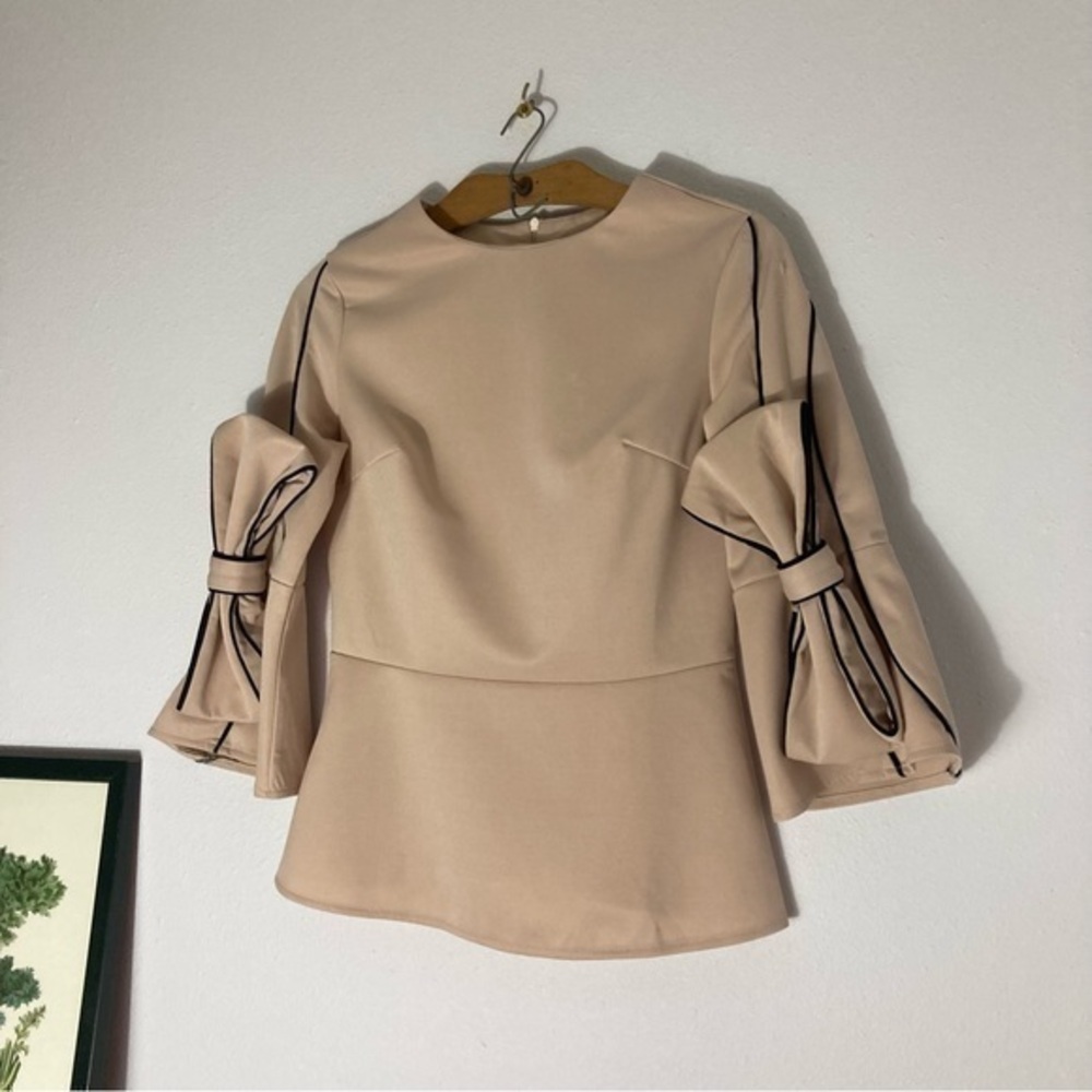 Pale pink peplum top with oversized bows size M